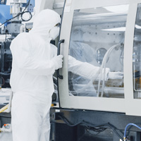 Man standing in front of semiconductor equipment